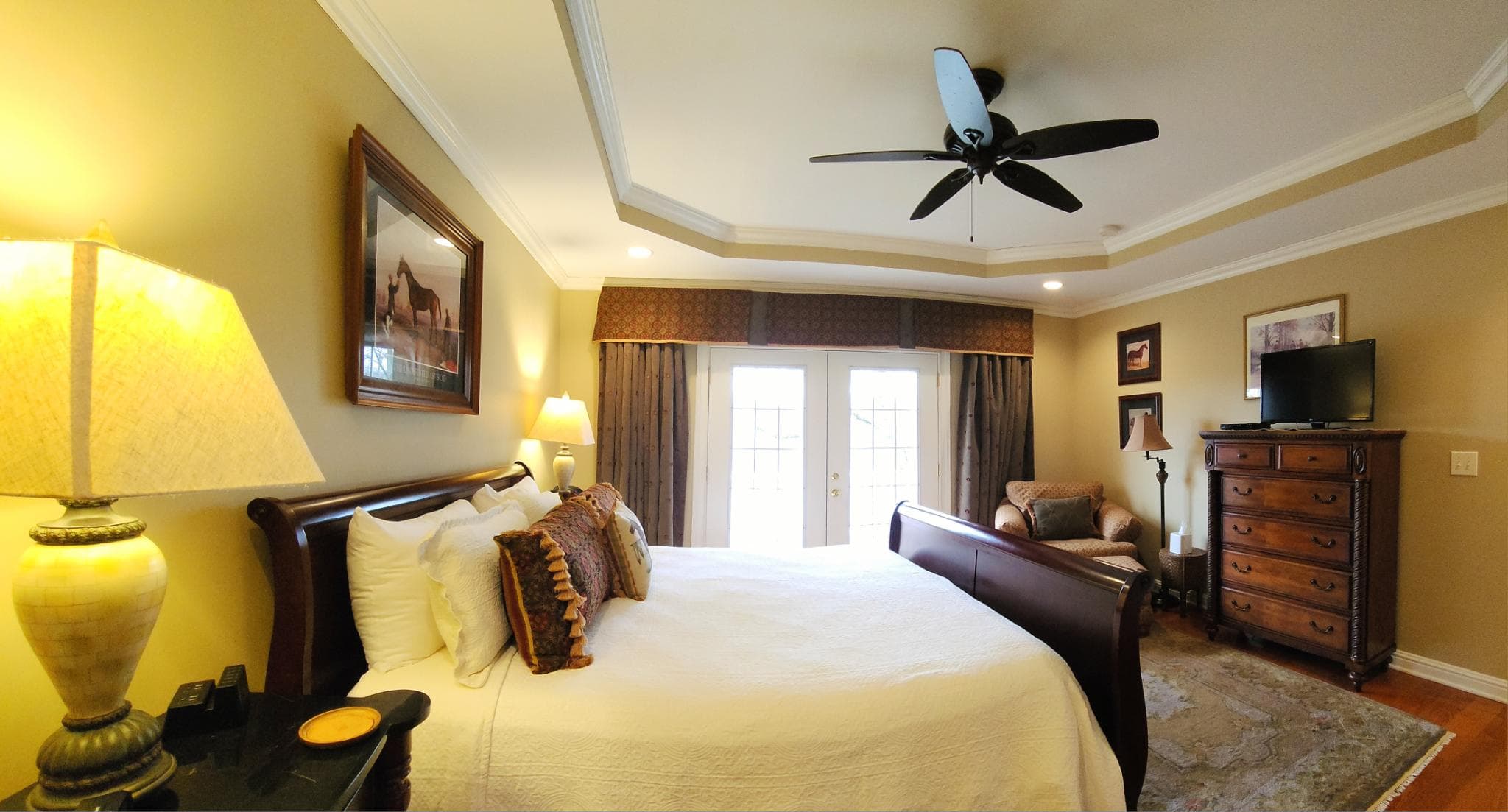 Cozy bedroom featuring a large bed, bedside lamp, and elegant decor.